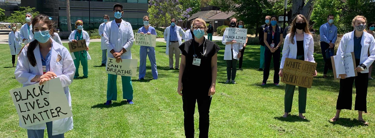 medical workers holding Black Lives Matter signs